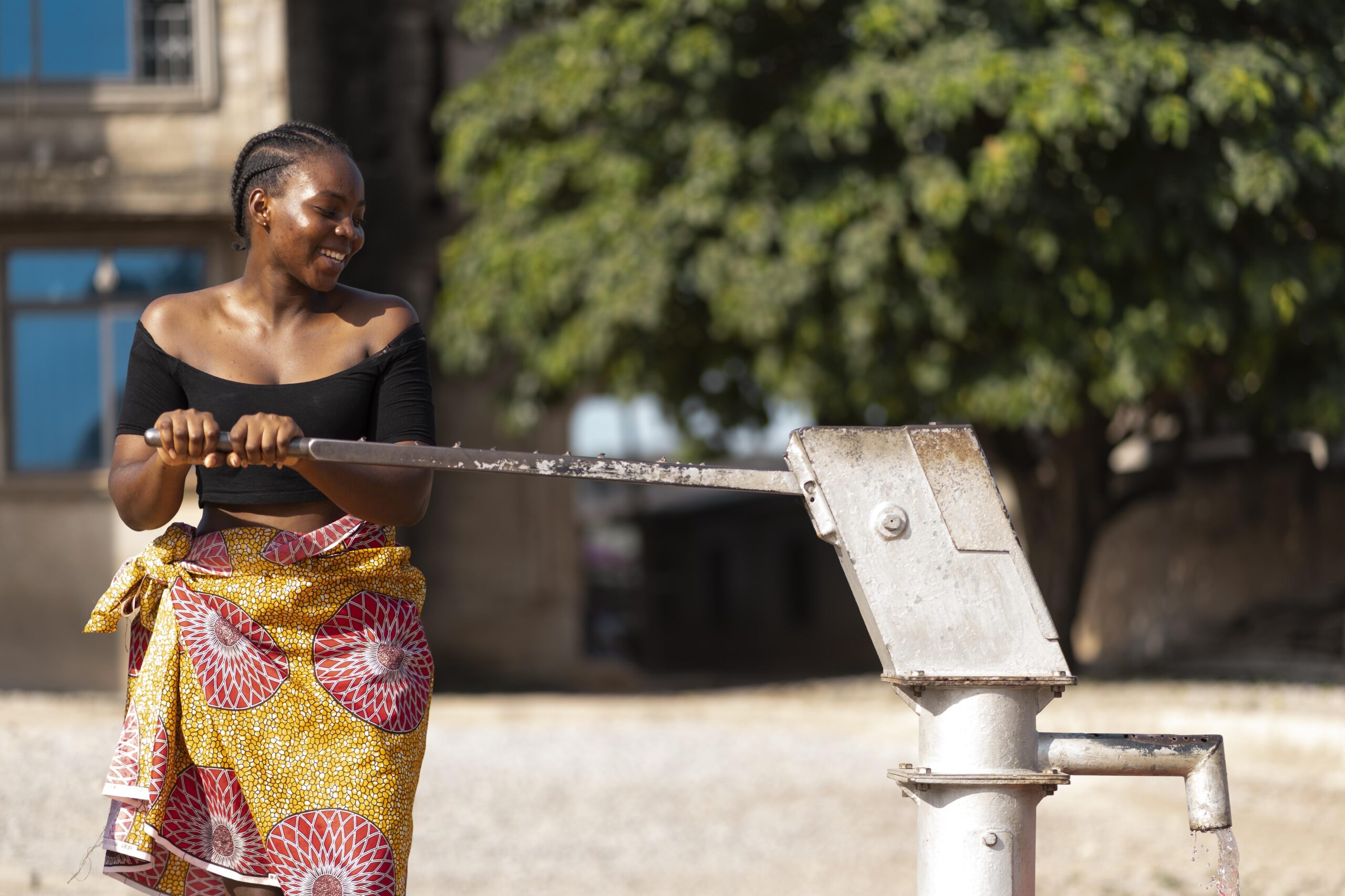 african woman pouring water recipient