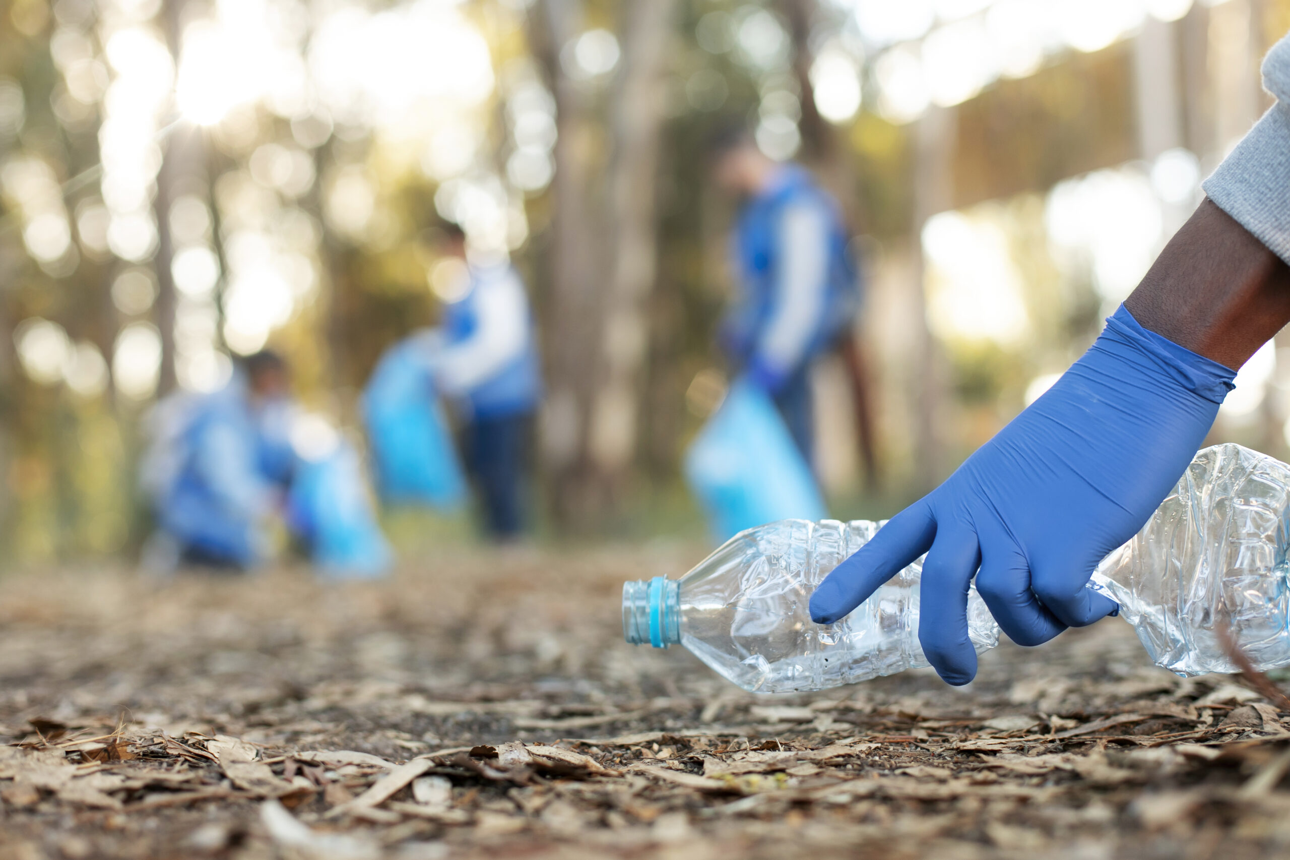 close up hand collecting bottle