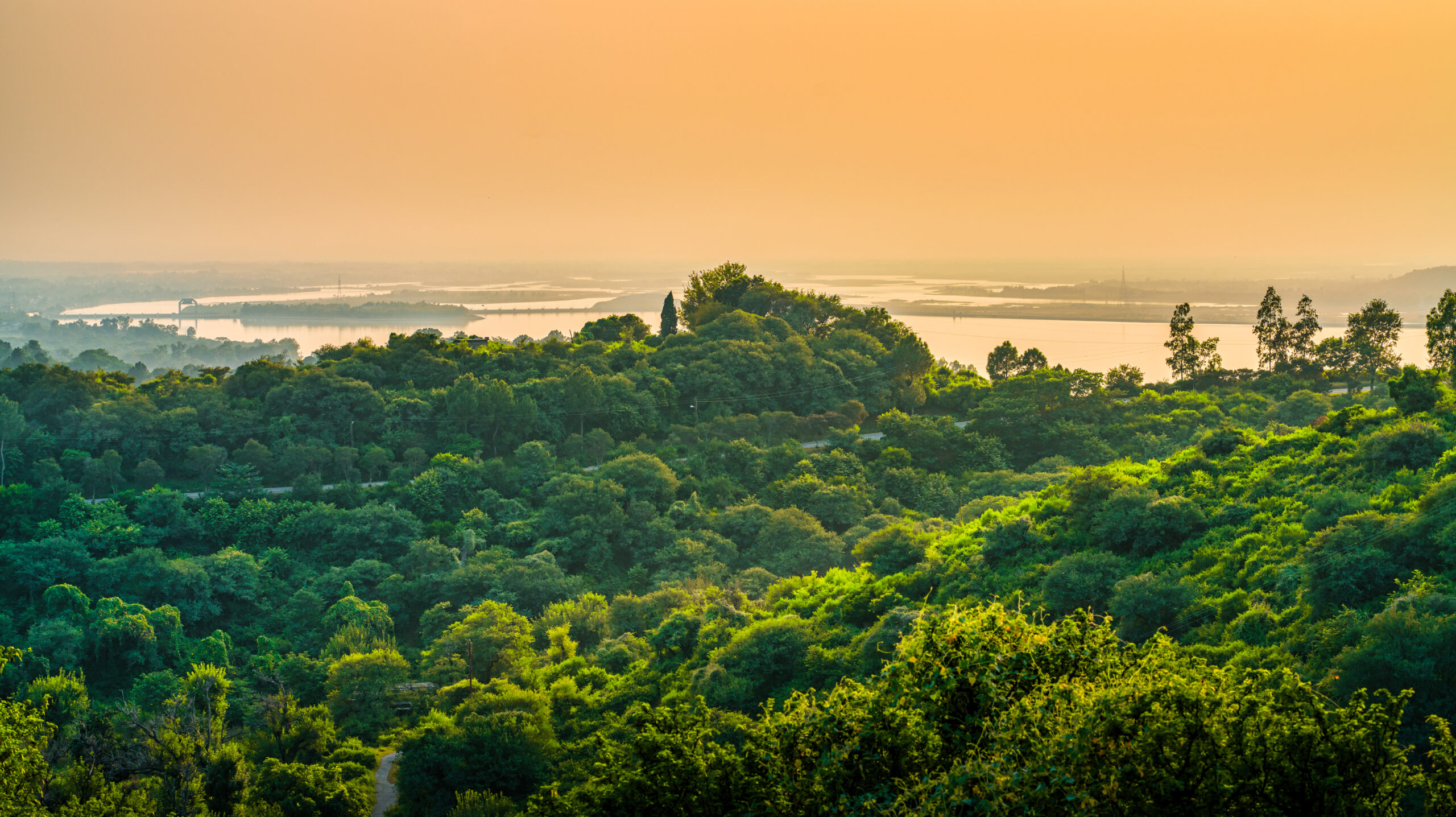 landscape hills covered greenery surrounded by sea cloudy sky sunset